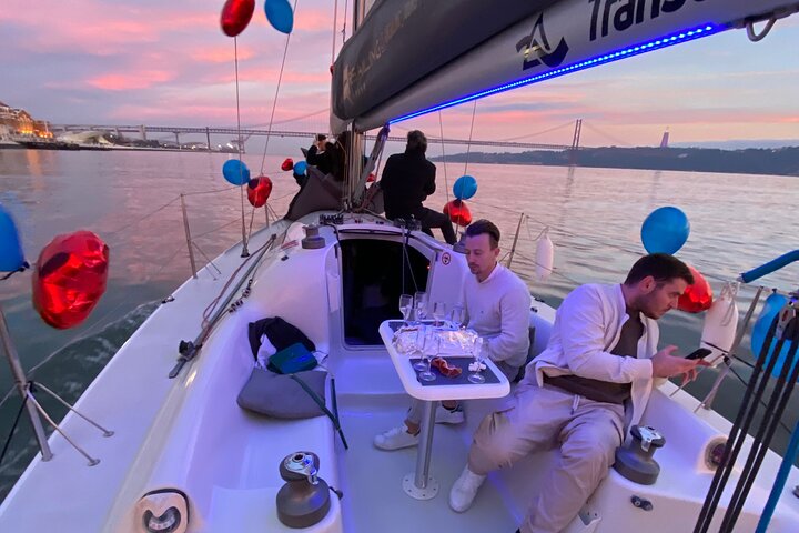 Sunset Sailboat Tour with Guide and Open Bar Green Wine In Lisbon